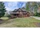 Handsome brick home showcasing a covered porch and well-kept yard in a leafy neighborhood at 220 Carriage Station Dr, Lawrenceville, GA 30046