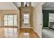Sunlit foyer featuring hardwood floors and a view of the front door and adjacent rooms at 220 Carriage Station Dr, Lawrenceville, GA 30046