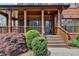 Inviting front porch showcasing brick columns and a well-landscaped entry at 220 Carriage Station Dr, Lawrenceville, GA 30046