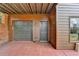 Attached garage and exterior door with red cement patio offering convenient access at 220 Carriage Station Dr, Lawrenceville, GA 30046