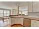 Open-concept kitchen with stainless steel appliances, white cabinets, and wood floors at 220 Carriage Station Dr, Lawrenceville, GA 30046