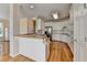 Kitchen area boasts white cabinets, modern appliances, and wood floors at 220 Carriage Station Dr, Lawrenceville, GA 30046