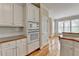 Kitchen with white cabinets, built-in appliances, and access to the breakfast area at 220 Carriage Station Dr, Lawrenceville, GA 30046