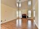 Living room featuring a fireplace, wood floors and many windows at 220 Carriage Station Dr, Lawrenceville, GA 30046