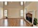 Inviting living room featuring a fireplace, wood floors, neutral paint and abundant natural light at 220 Carriage Station Dr, Lawrenceville, GA 30046