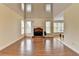 Living room featuring a fireplace, wood floors and many windows at 220 Carriage Station Dr, Lawrenceville, GA 30046
