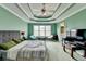Inviting main bedroom with a ceiling fan, carpet, and many windows at 220 Carriage Station Dr, Lawrenceville, GA 30046