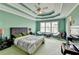 Inviting main bedroom with a ceiling fan, carpet, and many windows at 220 Carriage Station Dr, Lawrenceville, GA 30046