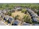 An aerial view showcases homes around a grassy common area at 4215 Evans Farms Dr, Cumming, GA 30040