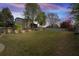 Expansive backyard with lush lawn, wooden fence, and mature trees, perfect for outdoor activities and relaxation at 4215 Evans Farms Dr, Cumming, GA 30040
