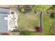 Aerial view of expansive backyard featuring lush green grass, a defined garden bed, and a stone patio at 4215 Evans Farms Dr, Cumming, GA 30040