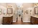 Elegant bathroom featuring dual vanities with dark wood cabinets and wood-look tile flooring at 4215 Evans Farms Dr, Cumming, GA 30040