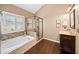 Bright bathroom featuring a soaking tub, a glass-enclosed shower, and vanity at 4215 Evans Farms Dr, Cumming, GA 30040