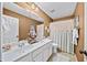 Traditional bathroom with double vanity, shell decor, and neutral colors at 4215 Evans Farms Dr, Cumming, GA 30040