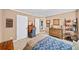 Bedroom with tan walls, patterned bedding, desk and chair, and lots of storage at 4215 Evans Farms Dr, Cumming, GA 30040