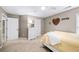 Bedroom with a white bed frame, neutral walls, ceiling fan, and beige carpet at 4215 Evans Farms Dr, Cumming, GA 30040
