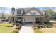 Charming clubhouse with stone accents, covered porch, and landscaped grounds, offering a community gathering space at 4215 Evans Farms Dr, Cumming, GA 30040