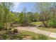 Spacious driveway leading to a serene property with lush trees at 4215 Evans Farms Dr, Cumming, GA 30040