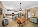 Spacious kitchen with stainless steel appliances, island, tile floors, and adjacent dining area at 4215 Evans Farms Dr, Cumming, GA 30040
