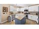 Well-lit kitchen offers an island, granite countertops, stainless steel appliances, and tile flooring at 4215 Evans Farms Dr, Cumming, GA 30040
