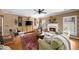Cozy living room with fireplace, hardwood flooring, and large windows for ample natural light at 4215 Evans Farms Dr, Cumming, GA 30040