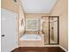 The main bathroom features a separate tub and shower, plus tile accents at 4215 Evans Farms Dr, Cumming, GA 30040
