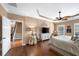 Spacious primary bedroom with wood floors, tray ceiling, and access to the ensuite bathroom at 4215 Evans Farms Dr, Cumming, GA 30040
