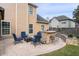 Backyard patio with outdoor bar, grill, and seating area with comfortable blue chairs and a fire pit at 4215 Evans Farms Dr, Cumming, GA 30040