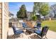 Backyard patio featuring an outdoor kitchen, stone counters, and seating around a cozy fire pit at 4215 Evans Farms Dr, Cumming, GA 30040