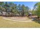 A community playground with swings and a slide surrounded by trees at 4215 Evans Farms Dr, Cumming, GA 30040