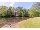 Scenic pond view surrounded by trees and vibrant greenery at 4215 Evans Farms Dr, Cumming, GA 30040