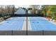 Community blue tennis courts are surrounded by a black fence at 4215 Evans Farms Dr, Cumming, GA 30040