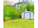 Backyard shows lush green lawn, foliage and a shed with easy access to storage at 4554 Saint Andrews Dr, Atlanta, GA 30331