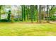 An expansive lawn with mature trees defines the backyard at 4554 Saint Andrews Dr, Atlanta, GA 30331