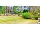 Expansive backyard features a lush lawn, mature trees, and a chain-link fence at 4554 Saint Andrews Dr, Atlanta, GA 30331