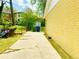 Side view of yellow brick home with long driveway and fenced in backyard with storage shed at 4554 Saint Andrews Dr, Atlanta, GA 30331