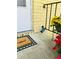 The front porch includes a welcome mat, flower planter, and charming yellow flowers at 4554 Saint Andrews Dr, Atlanta, GA 30331