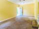 Cozy living room featuring neutral carpet, a ceiling fan, and natural light from the front door at 4554 Saint Andrews Dr, Atlanta, GA 30331