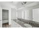 Bathroom boasts double granite vanities with stainless fixtures and wood look floors at 795 Clark Lake Estates Dr, Grayson, GA 30017