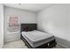 Comfortable bedroom with carpet flooring, a window, and a black platform bed at 795 Clark Lake Estates Dr, Grayson, GA 30017