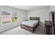 Bedroom showcases grey carpet, bright natural light, and rustic wood furniture at 795 Clark Lake Estates Dr, Grayson, GA 30017