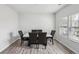 Dining room with luxury vinyl plank flooring, windows, and a six-chair dining table at 795 Clark Lake Estates Dr, Grayson, GA 30017