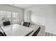 Bright dining area featuring vinyl plank flooring, windows, and a marble top table at 795 Clark Lake Estates Dr, Grayson, GA 30017