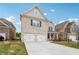 Charming two-story brick home featuring a two-car garage and a spacious driveway at 795 Clark Lake Estates Dr, Grayson, GA 30017