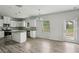 Kitchen featuring granite counters, stainless steel appliances, white cabinets, and vinyl flooring at 795 Clark Lake Estates Dr, Grayson, GA 30017