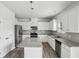 Modern kitchen featuring granite countertops, stainless steel appliances, and white cabinets at 795 Clark Lake Estates Dr, Grayson, GA 30017