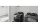 Laundry room featuring dark steel appliances and a storage shelf at 795 Clark Lake Estates Dr, Grayson, GA 30017