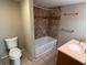 Clean bathroom equipped with vanity, toilet, and a tiled shower and bath at 1938 Main Nw St, Atlanta, GA 30318