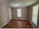 Cozy bedroom featuring hardwood floors, a window for natural light, and a closet at 1938 Main Nw St, Atlanta, GA 30318