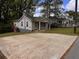 View of home featuring a large driveway, lush lawn and inviting outdoor space at 1938 Main Nw St, Atlanta, GA 30318